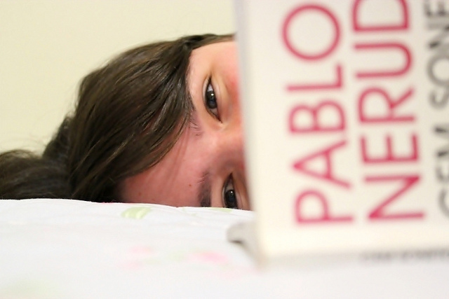girl reading pablo neruda book