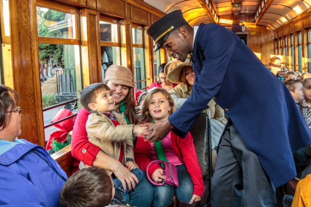 Boy shaking hand of conductor